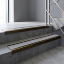 Bronze square edge aluminium stair nosing with Light Grey Smooth Textured infill, fitted to a concrete step