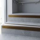 Bronze square edge aluminium stair nosing with Mill Aluminium infill, fitted to a concrete step