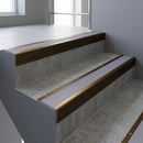 Bronze square edge aluminium stair nosing with Nimbus Castellated infill, fitted to a concrete step