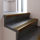 Bronze square edge aluminium stair nosing with Olive Castellated infill, fitted to a concrete step