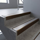Bronze square edge aluminium stair nosing with Polished Aluminium infill, fitted to a concrete step