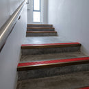 Bronze square edge aluminium stair nosing with Poppy Castellated infill, fitted to a concrete step