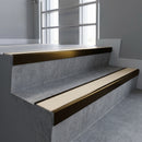 Bronze square edge aluminium stair nosing with Porth Stone Castellated infill, fitted to a concrete step