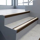 Bronze square edge aluminium stair nosing with Porth Stone Smooth Textured infill, fitted to a concrete step