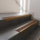 Bronze square edge aluminium stair nosing with Rustic Castellated infill, fitted to a concrete step