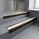 Bronze square edge aluminium stair nosing with White Castellated infill, fitted to a concrete step