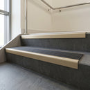 Light Bronze square edge aluminium stair nosing with Black Castellated infill, fitted to a concrete step