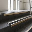 Light Bronze square edge aluminium stair nosing with Black Olympic Grip infill, fitted to a concrete step