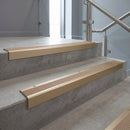 Light Bronze square edge aluminium stair nosing with Fawn Castellated infill, fitted to a concrete step