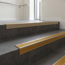 Light Bronze square edge aluminium stair nosing with Gold Castellated infill, fitted to a concrete step