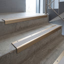 Light Bronze square edge aluminium stair nosing with Light Grey Smooth Textured infill, fitted to a concrete step