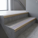 Light Bronze square edge aluminium stair nosing with Nimbus Castellated infill, fitted to a concrete step