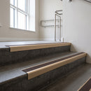 Light Bronze square edge aluminium stair nosing with Peat Castellated infill, fitted to a concrete step