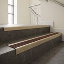 Light Bronze square edge aluminium stair nosing with Rustic Castellated infill, fitted to a concrete step