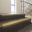 Light Bronze square edge aluminium stair nosing with Yellow Castellated infill, fitted to a concrete step