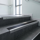 Mill Aluminium square edge aluminium stair nosing with Black Smooth Textured infill, fitted to a concrete step