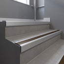 Mill Aluminium square edge aluminium stair nosing with Bronze Aluminium infill, fitted to a concrete step