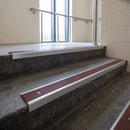 Mill Aluminium square edge aluminium stair nosing with Claret Castellated infill, fitted to a concrete step