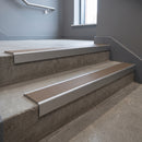 Mill Aluminium square edge aluminium stair nosing with Fawn Castellated infill, fitted to a concrete step