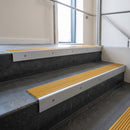 Mill Aluminium square edge aluminium stair nosing with Gold Castellated infill, fitted to a concrete step