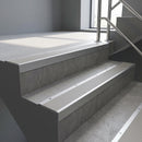 Mill Aluminium square edge aluminium stair nosing with Light Grey Castellated infill, fitted to a concrete step