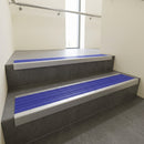 Mill Aluminium square edge aluminium stair nosing with Mid Blue Castellated infill, fitted to a concrete step