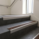 Mill Aluminium square edge aluminium stair nosing with Peat Castellated infill, fitted to a concrete step