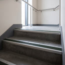 Mill Aluminium square edge aluminium stair nosing with Spruce Castellated infill, fitted to a concrete step