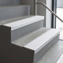 Mill Aluminium square edge aluminium stair nosing with White Castellated infill, fitted to a concrete step