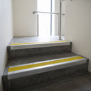 Mill Aluminium square edge aluminium stair nosing with Yellow Castellated infill, fitted to a concrete step