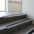 Polished Aluminium square edge aluminium stair nosing with Black Olympic Grip infill, fitted to a concrete step