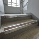 Polished Aluminium square edge aluminium stair nosing with Fawn Castellated infill, fitted to a concrete step