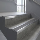 Polished Aluminium square edge aluminium stair nosing with Flint Castellated infill, fitted to a concrete step
