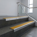 Polished Aluminium square edge aluminium stair nosing with Gold Castellated infill, fitted to a concrete step