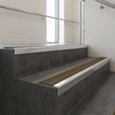 Polished Aluminium square edge aluminium stair nosing with Olive Castellated infill, fitted to a concrete step