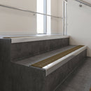 Polished Aluminium finish with Olive Castellated insert - Aluminium Stair Nosing 59x30mm Slimline Square Back fitted to a step edge