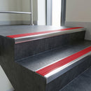 Polished Aluminium square edge aluminium stair nosing with Poppy Castellated infill, fitted to a concrete step