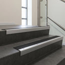 Satin Aluminium square edge aluminium stair nosing with Black Castellated infill, fitted to a concrete step