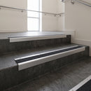 Satin Aluminium square edge aluminium stair nosing with Black Olympic Grip infill, fitted to a concrete step