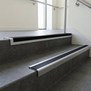 Satin Aluminium square edge aluminium stair nosing with Black Smooth Textured infill, fitted to a concrete step