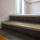 Satin Aluminium square edge aluminium stair nosing with Gold Castellated infill, fitted to a concrete step