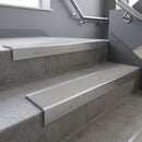 Satin Aluminium square edge aluminium stair nosing with Light Grey Castellated infill, fitted to a concrete step