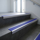 Satin Aluminium square edge aluminium stair nosing with Mid Blue Castellated infill, fitted to a concrete step