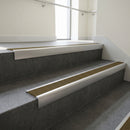 Satin Aluminium square edge aluminium stair nosing with Olive Castellated infill, fitted to a concrete step