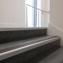 Satin Aluminium square edge aluminium stair nosing with Peat Castellated infill, fitted to a concrete step