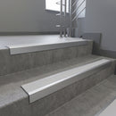 Satin Aluminium square edge aluminium stair nosing with Polar Grey Castellated infill, fitted to a concrete step