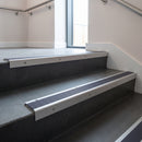 Satin Aluminium square edge aluminium stair nosing with Regency Castellated infill, fitted to a concrete step