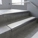 Satin Aluminium square edge aluminium stair nosing with White Castellated infill, fitted to a concrete step