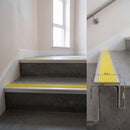 Satin Aluminium square edge aluminium stair nosing with Yellow Castellated infill, fitted to a concrete step