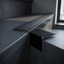 Aluminium Stair Nosing 63.5mm Tread Raked Back Single Channel in black anodised finish fitted on a step edge